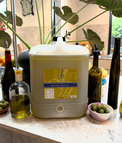 20 litre Olive Blue extra virgin olive oil container on kitchen counter with bottles and olives